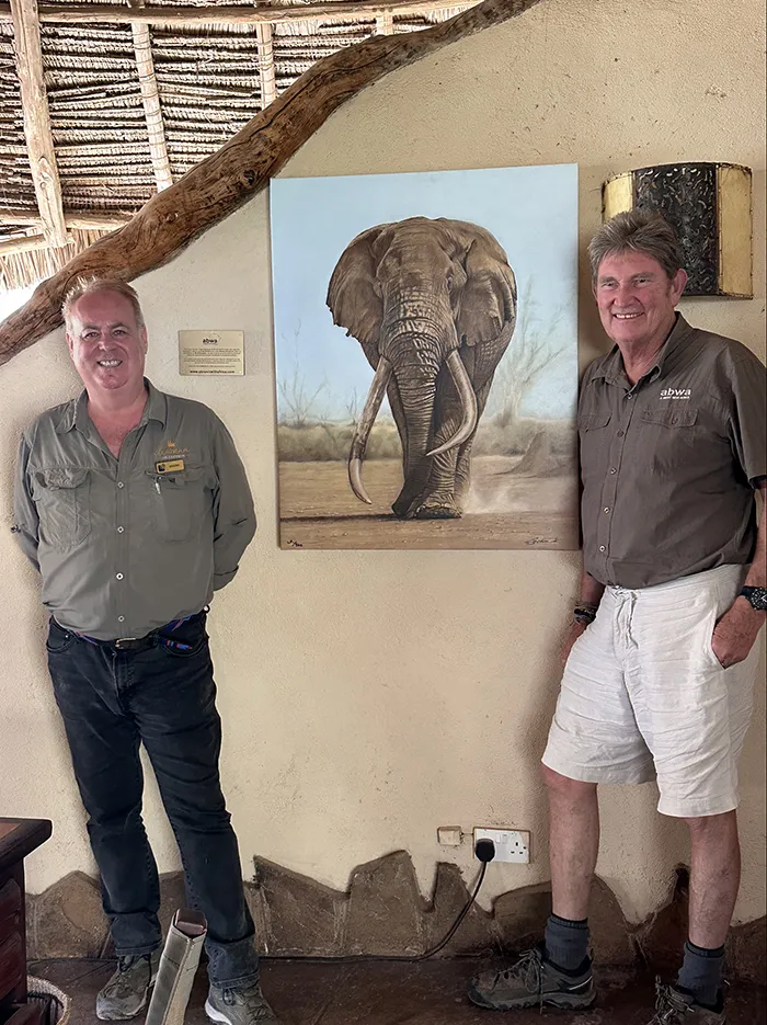 2023 - Simon handing over a canvas of the late super tusker 'Tim' to Graeme Smith at Tortilis Camp, Amboseli